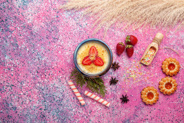 甜点顶视图美味的奶油甜点与红色切片草莓和饼干浅粉色背景甜点冰淇淋甜浆果水果浆果视图